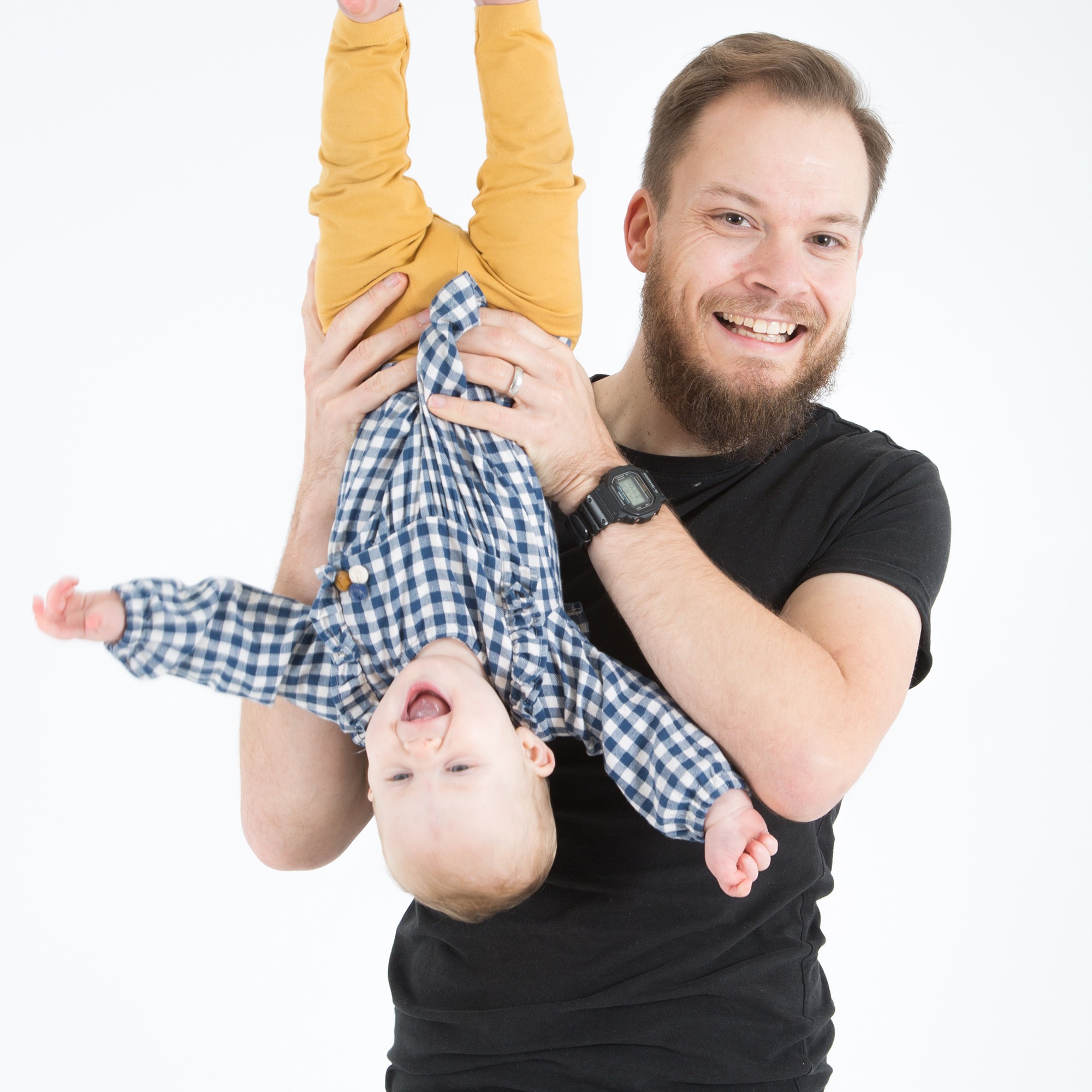 Dad Holding Baby Upside Down Laughing Bristol Portrait Studio Photographer Gallery Image by West 70 Photography in Downend